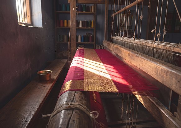 Woman weaving on a traditional handloom